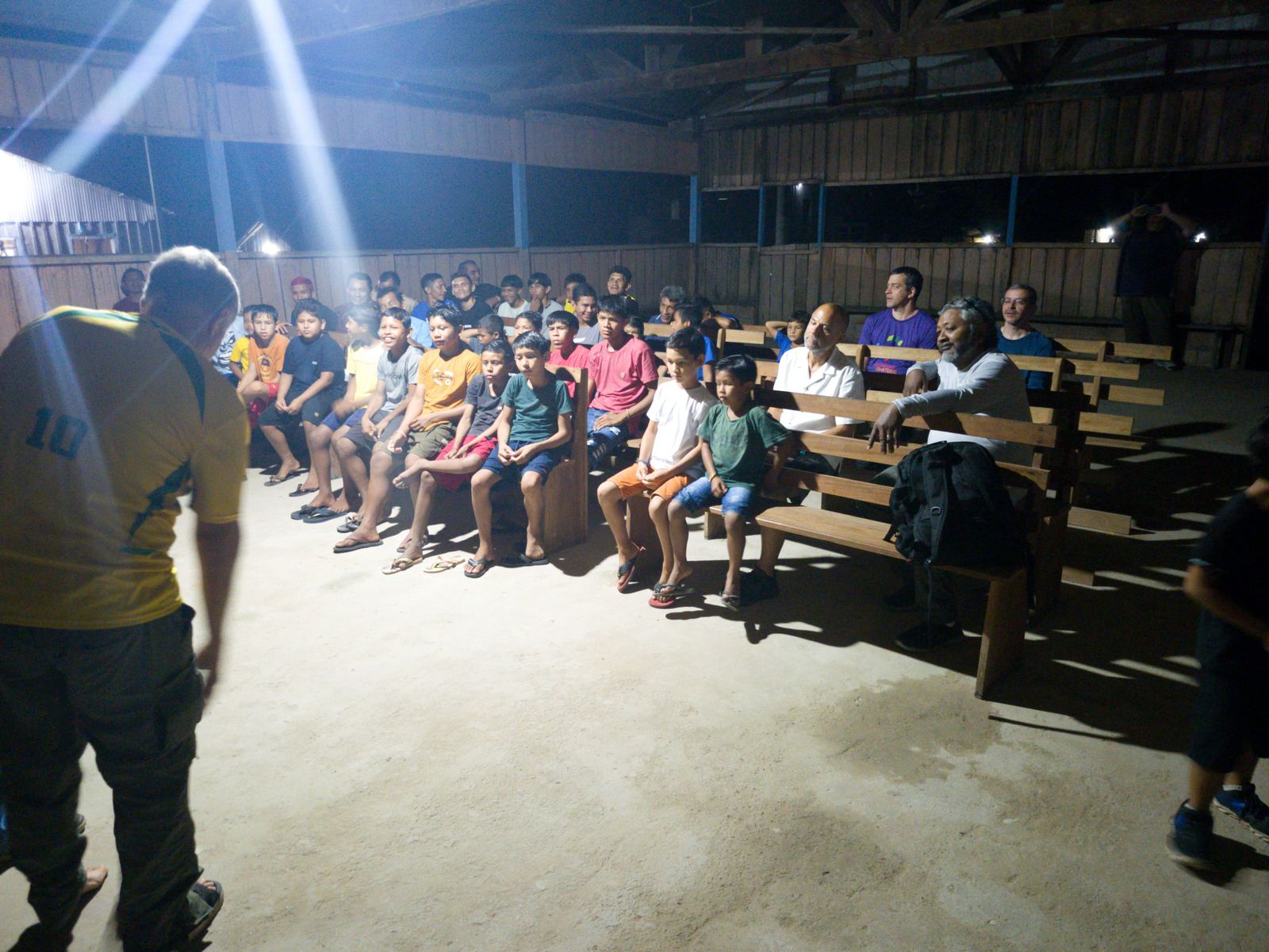 An evening gathering in a large open hall in Brazil