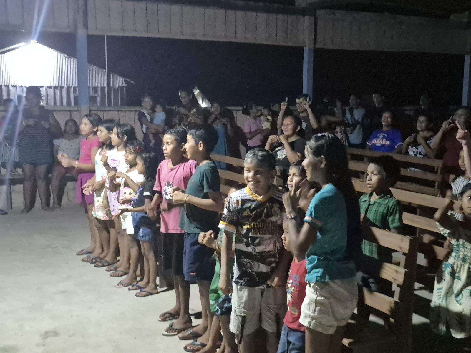 Children and families gathered in a hall in Brazil