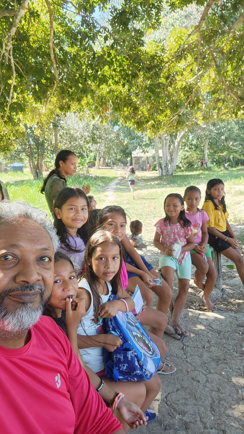 A team member with a group of smiling children in Brazil