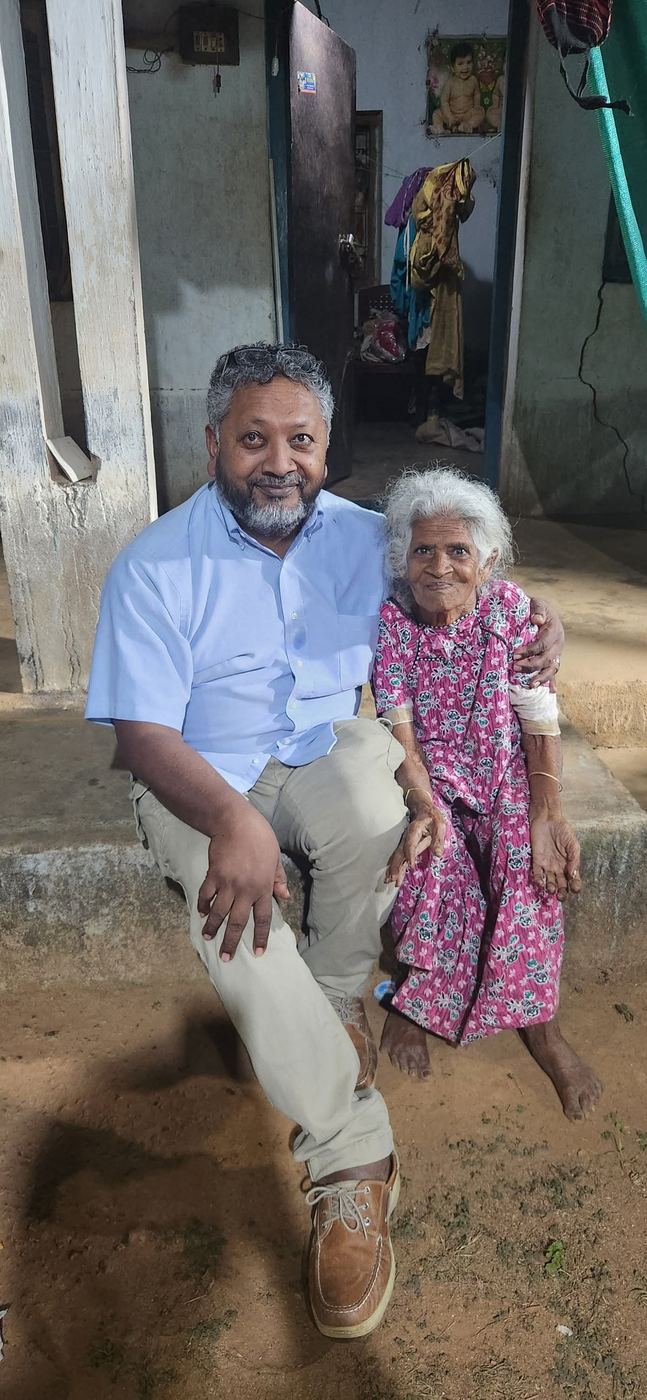 Kris Ramsingh with an elderly woman in India