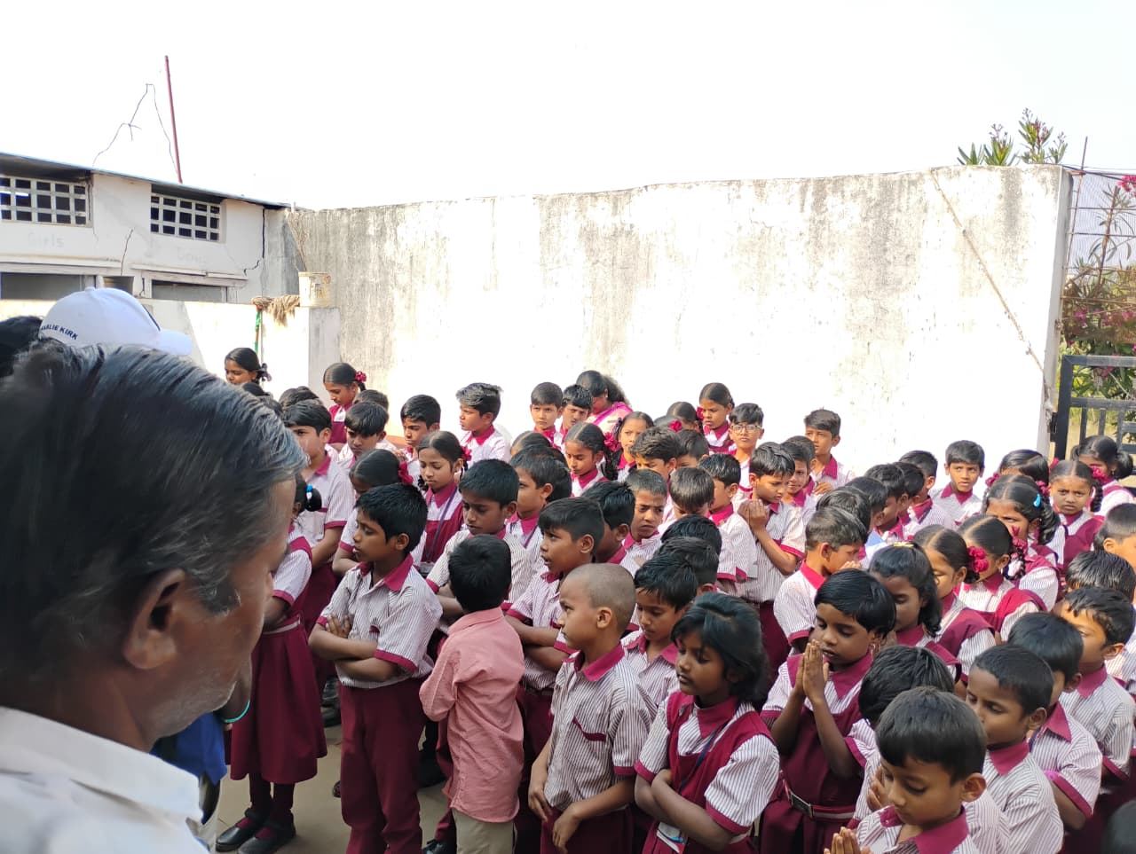 Schoolchildren in uniform gathered outside a school in India