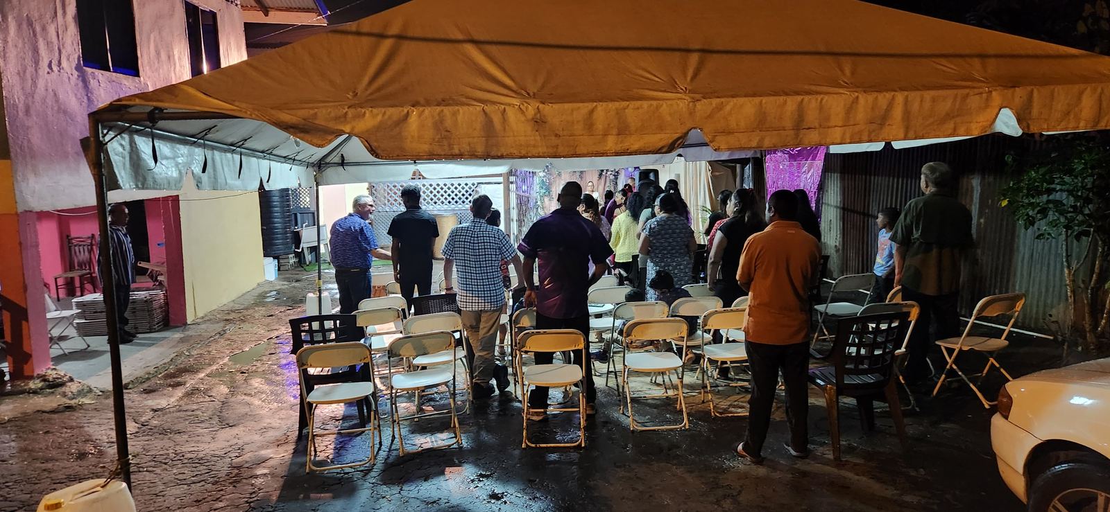 An evening gathering under a canopy in Trinidad