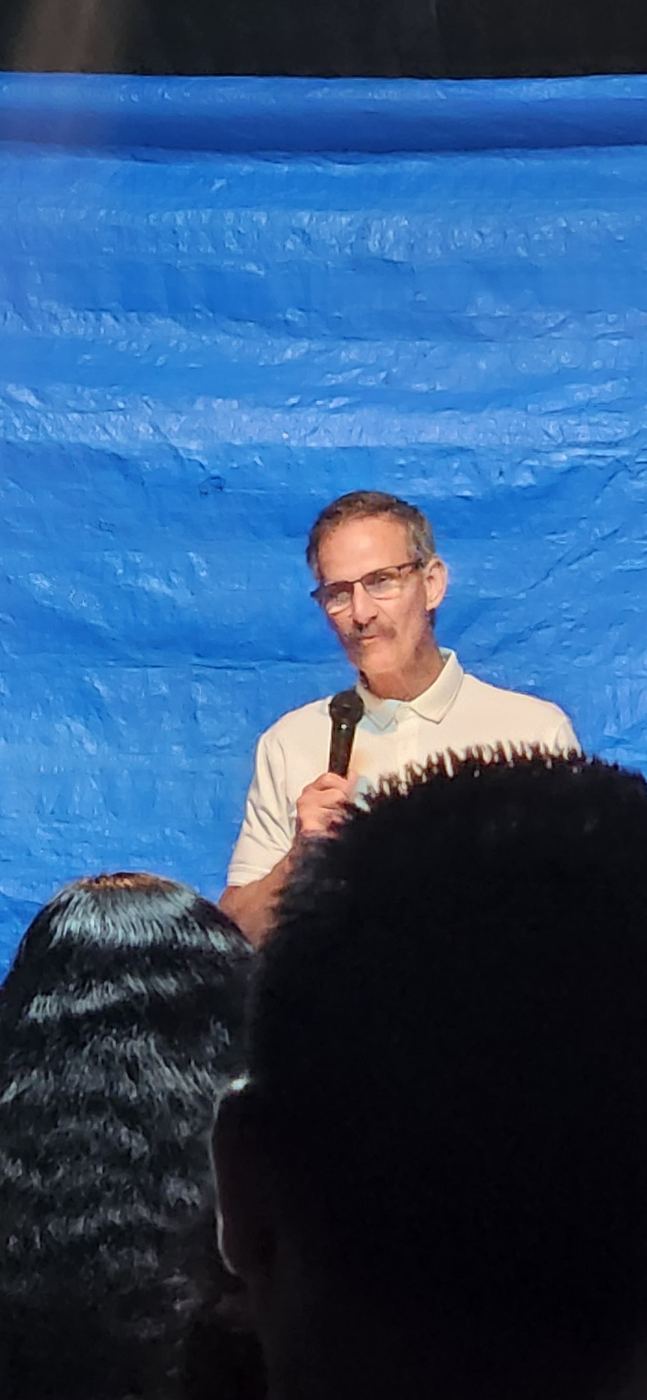 Preaching in front of a blue tarp in Trinidad